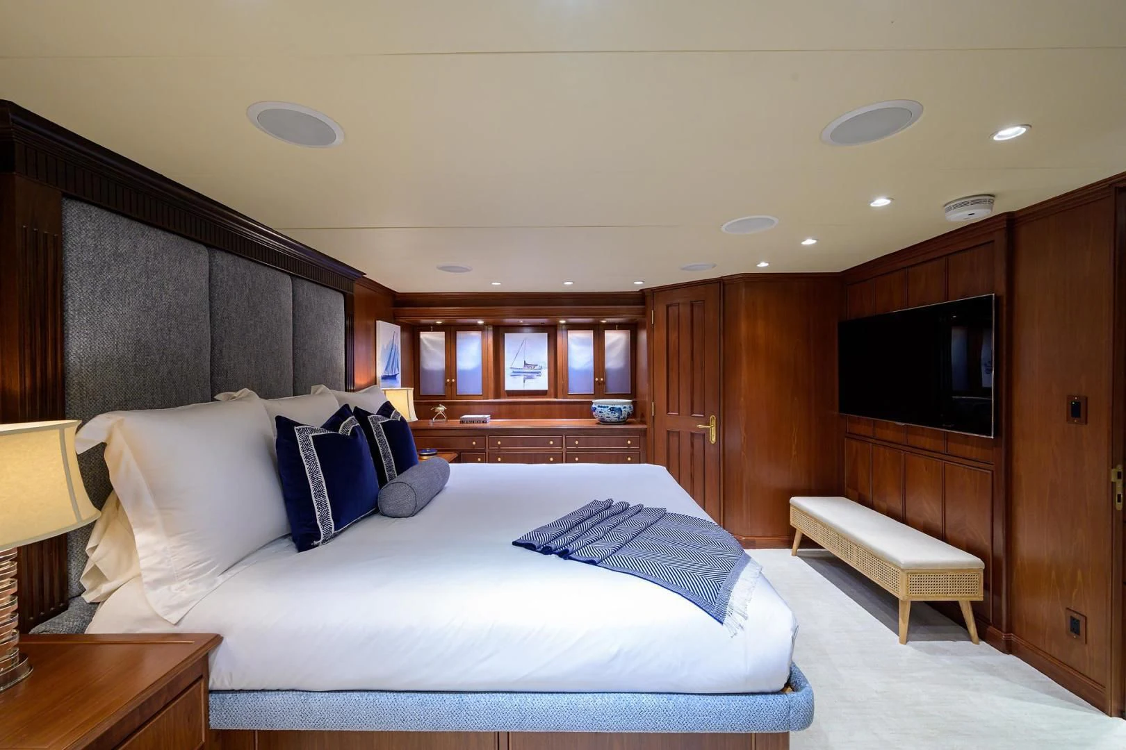 a bedroom with a bed and a tv aboard CHECKERS Yacht for Sale