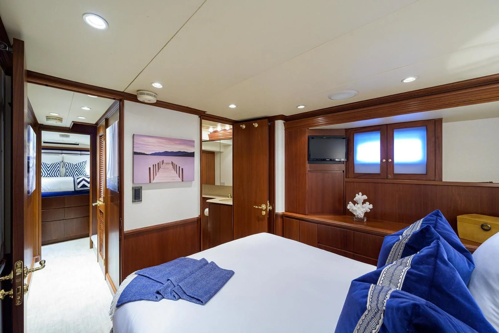 a bedroom with a wood door aboard CHECKERS Yacht for Sale