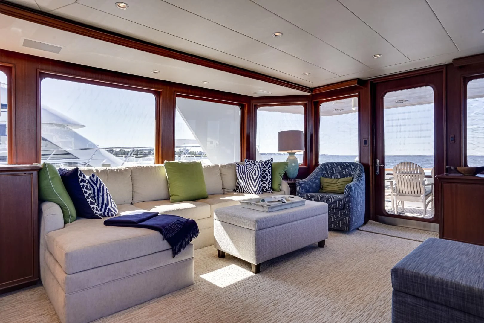 a living room with a blue couch aboard CHECKERS Yacht for Sale