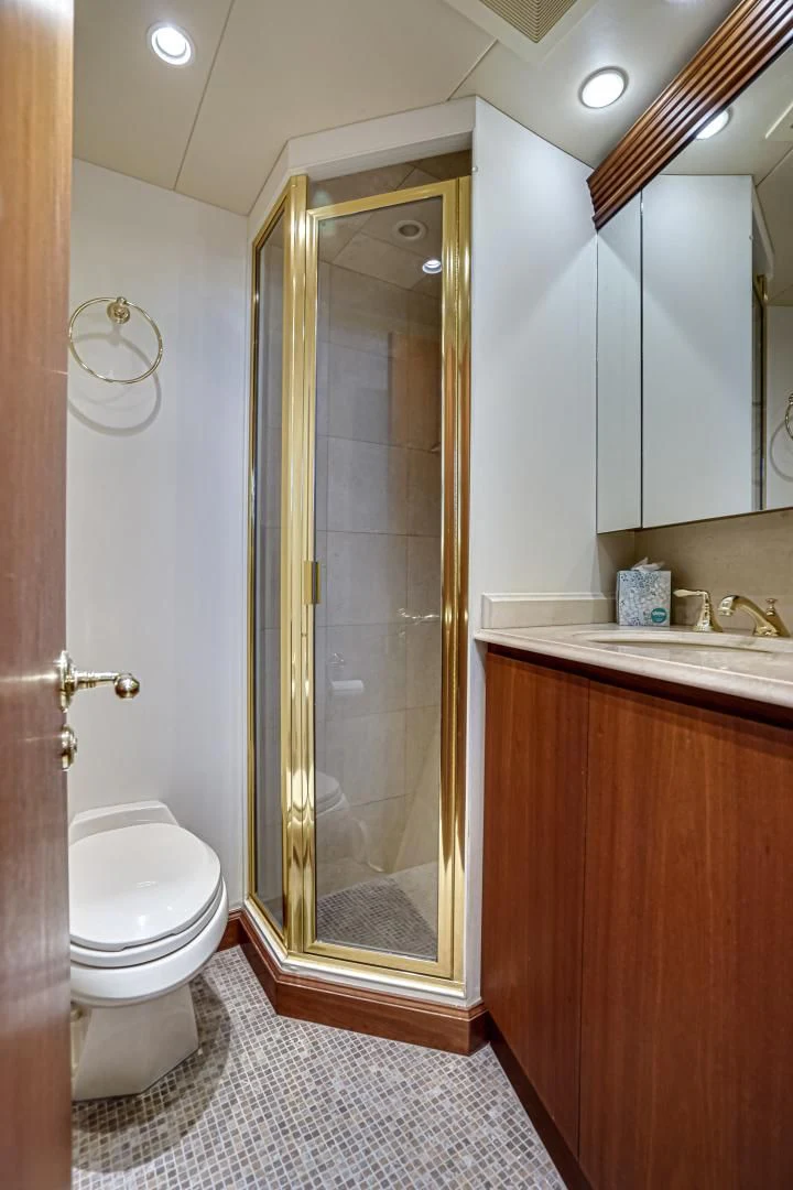 a bathroom with a glass shower door aboard CHECKERS Yacht for Sale