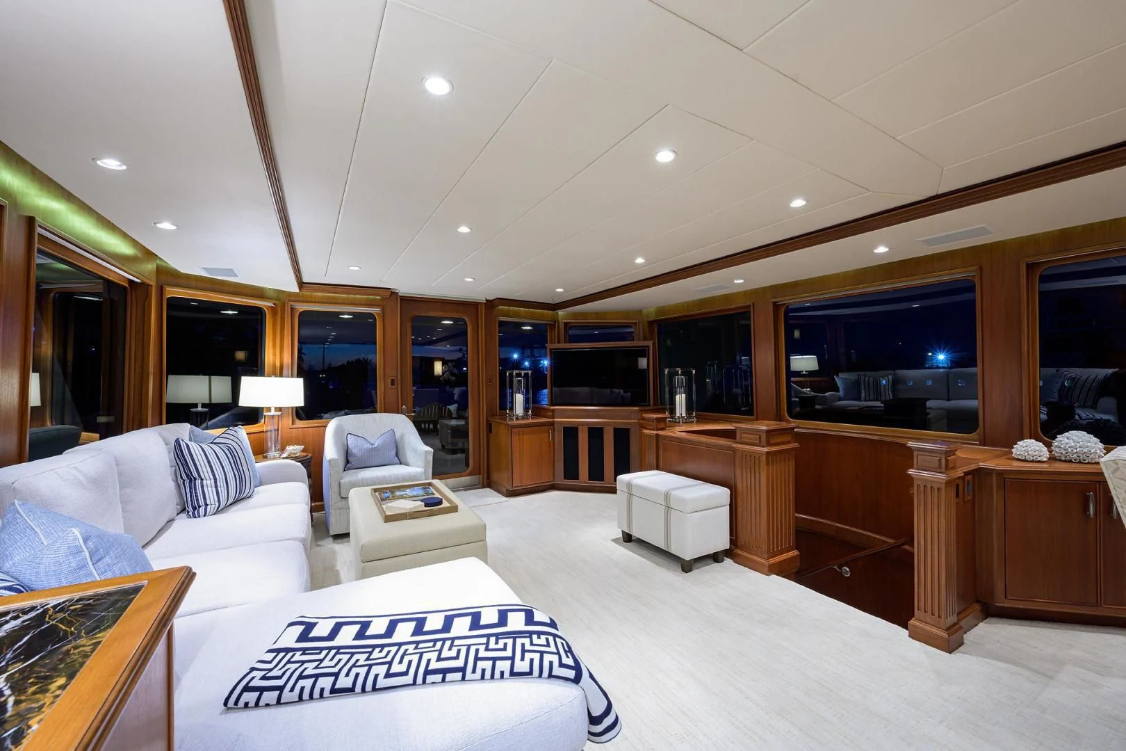 a large living room with a large kitchen and dining area aboard CHECKERS Yacht for Sale