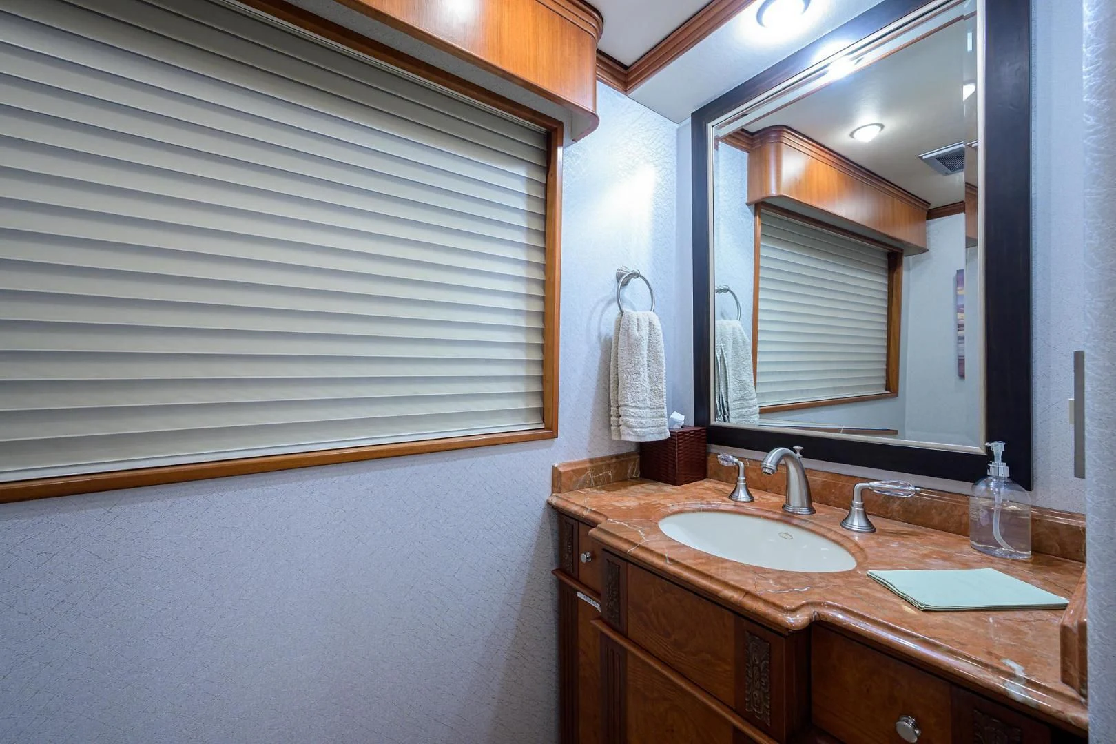 a bathroom with a sink and a mirror aboard CHECKERS Yacht for Sale