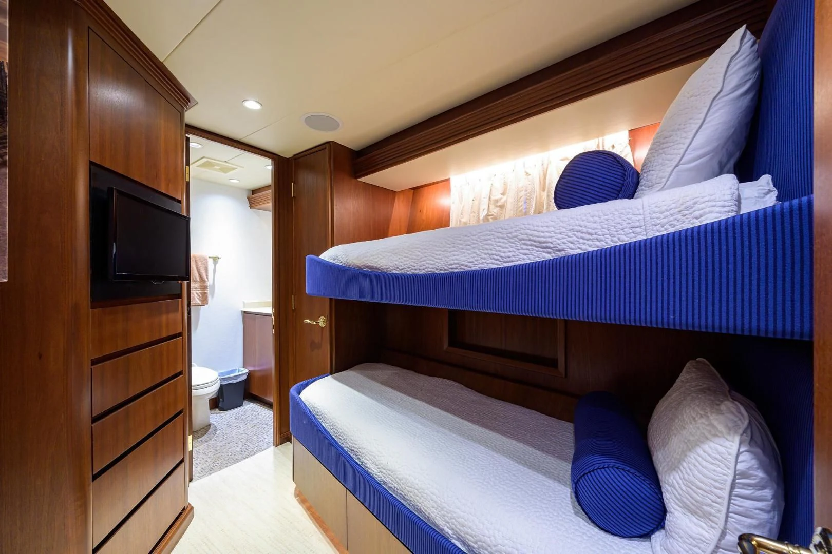 a bed with a blue cover aboard CHECKERS Yacht for Sale