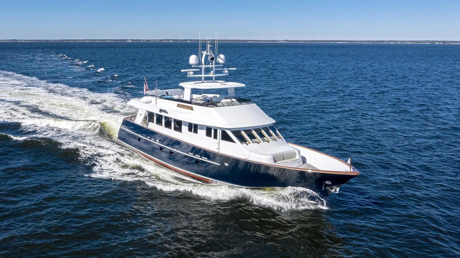 a large white boat on the water aboard CHECKERS Yacht for Sale