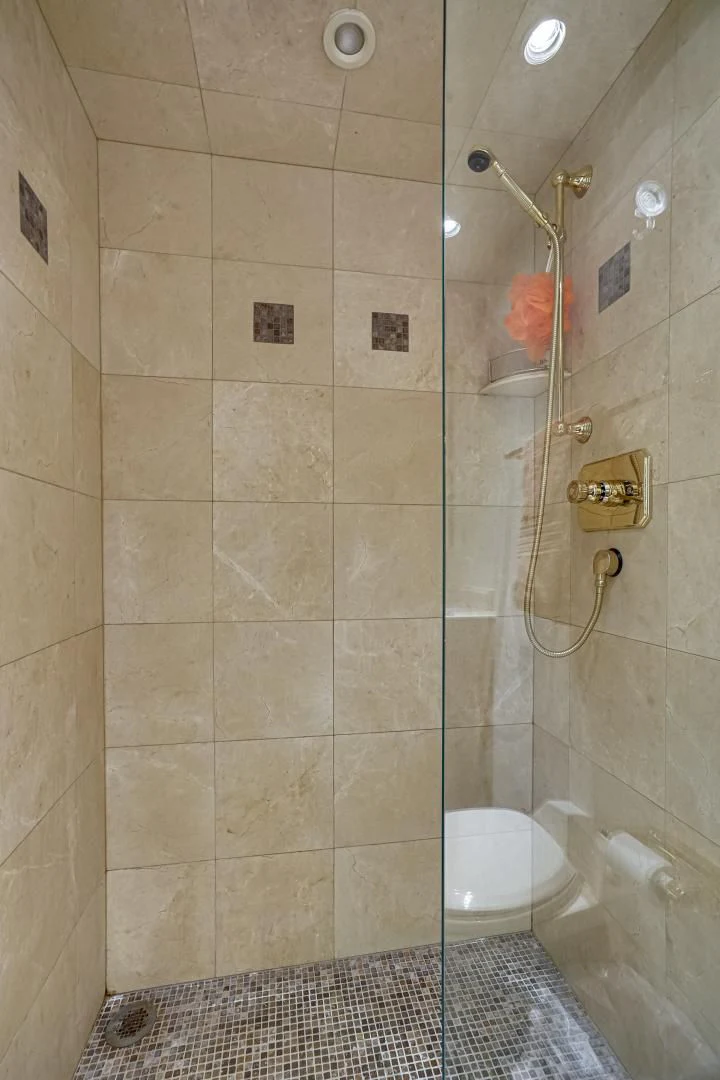 a shower with a tile floor aboard CHECKERS Yacht for Sale