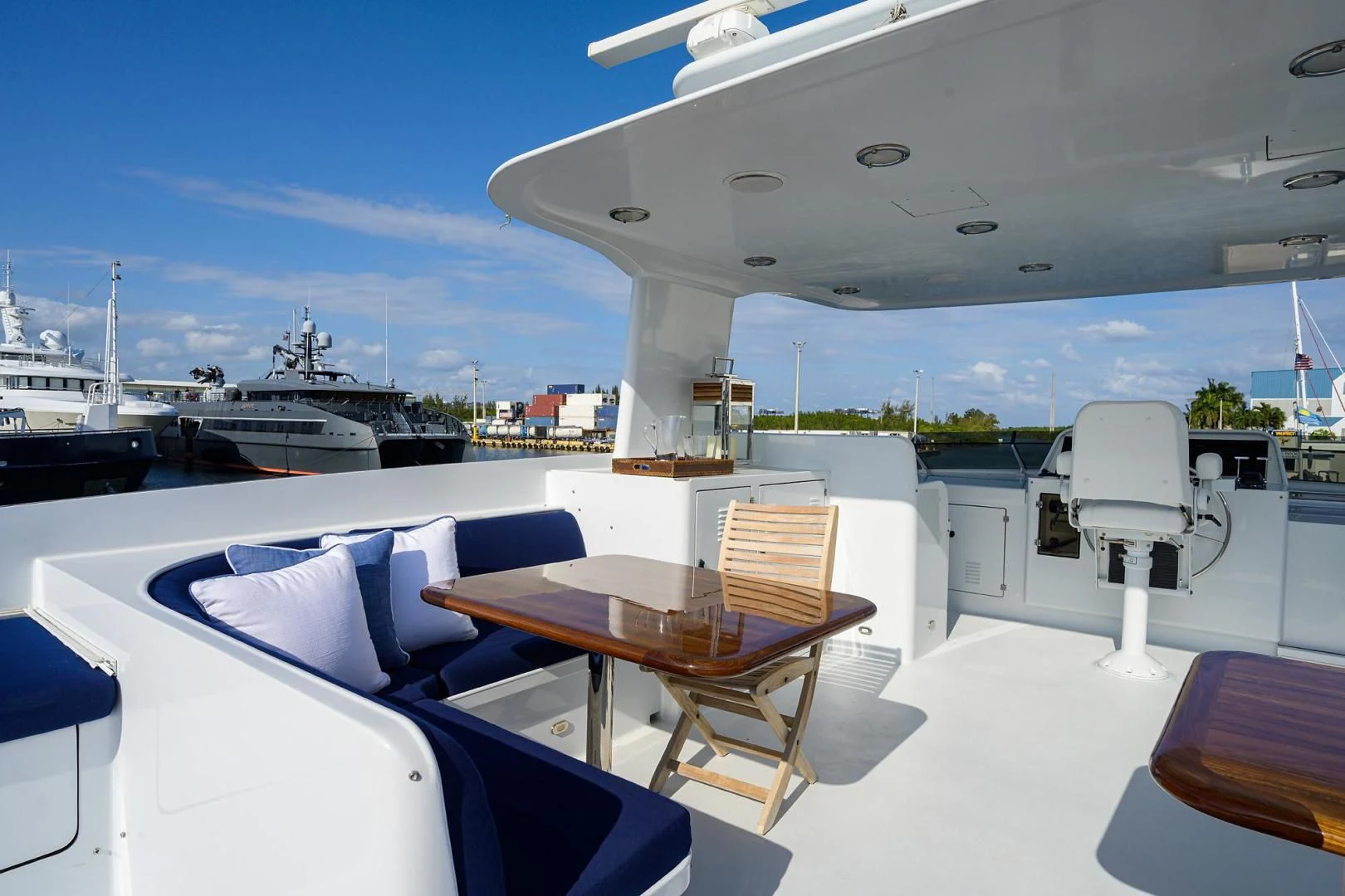 a boat dock with tables and chairs aboard CHECKERS Yacht for Sale