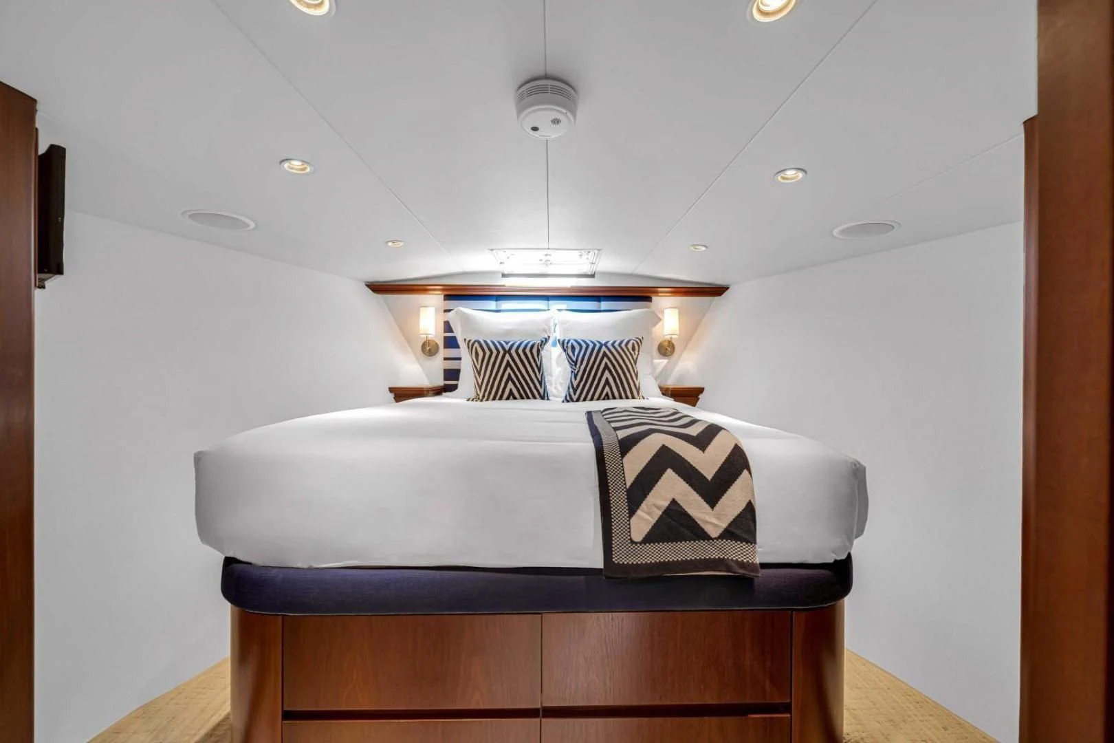 a bed with a white sheet on it aboard CHECKERS Yacht for Sale