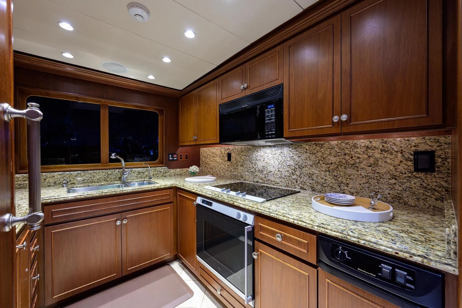 a kitchen with wooden cabinets aboard CHECKERS Yacht for Sale