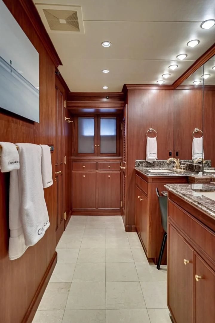 a bathroom with wooden cabinets aboard CHECKERS Yacht for Sale