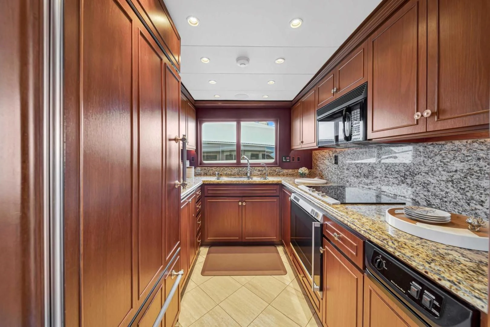 a kitchen with wooden cabinets aboard CHECKERS Yacht for Sale
