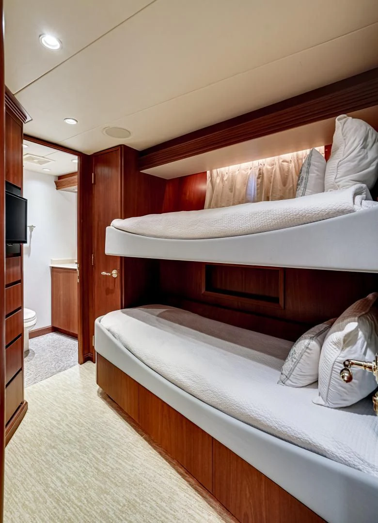 a bed with white sheets aboard CHECKERS Yacht for Sale