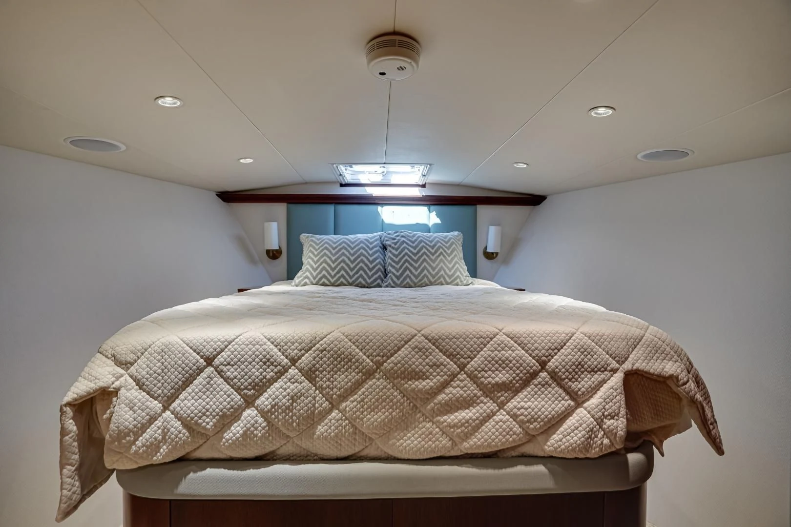 a bed with a white comforter aboard CHECKERS Yacht for Sale