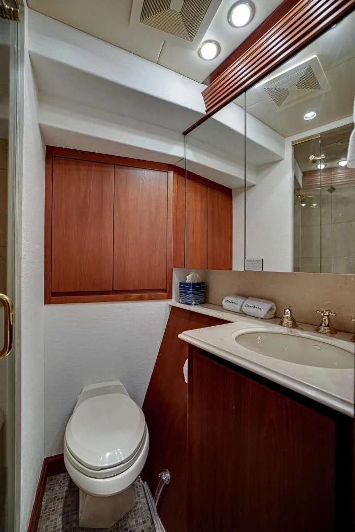 a bathroom with a toilet and sink aboard CHECKERS Yacht for Sale
