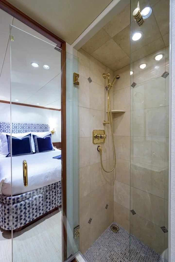 a bathroom with a glass shower aboard CHECKERS Yacht for Sale