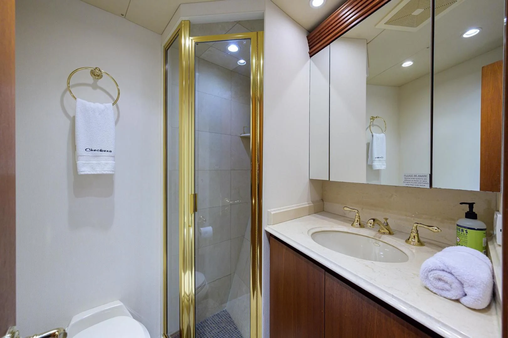 a bathroom with a sink and mirror aboard CHECKERS Yacht for Sale