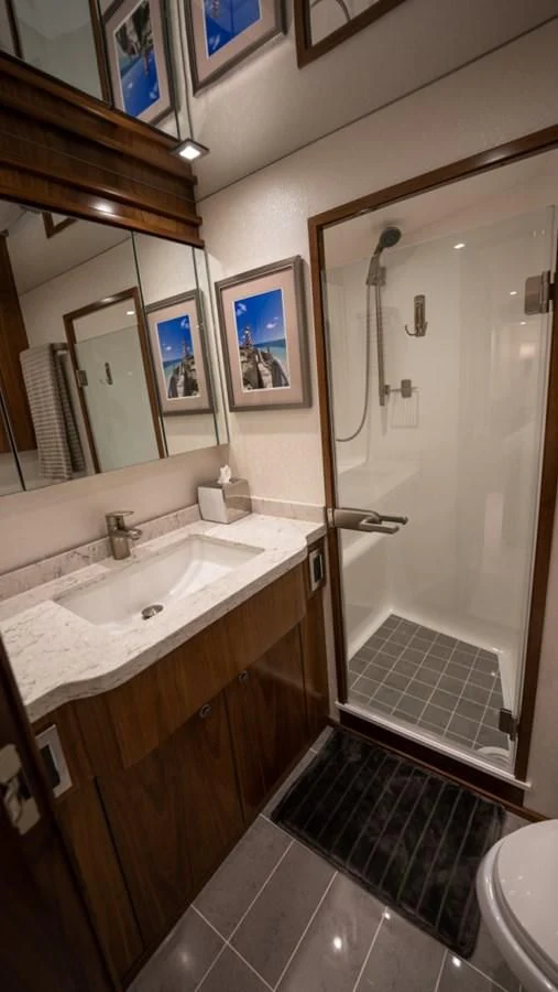 a bathroom with a shower and sink aboard WHY WOULDN'T WE Yacht for Sale