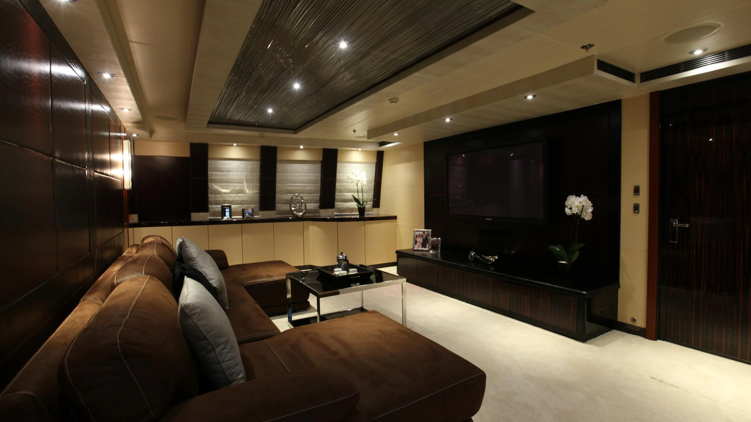 a living room with a large television aboard AQUANOVA Yacht for Sale