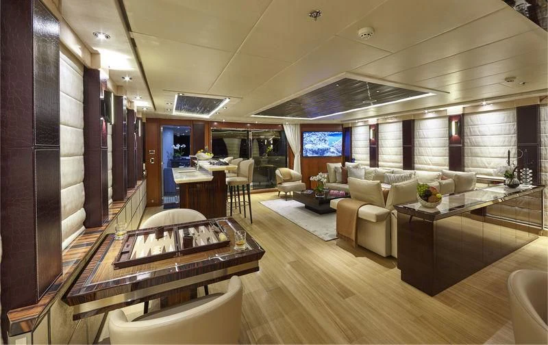 a room with a table chairs and a couch aboard AQUANOVA Yacht for Sale