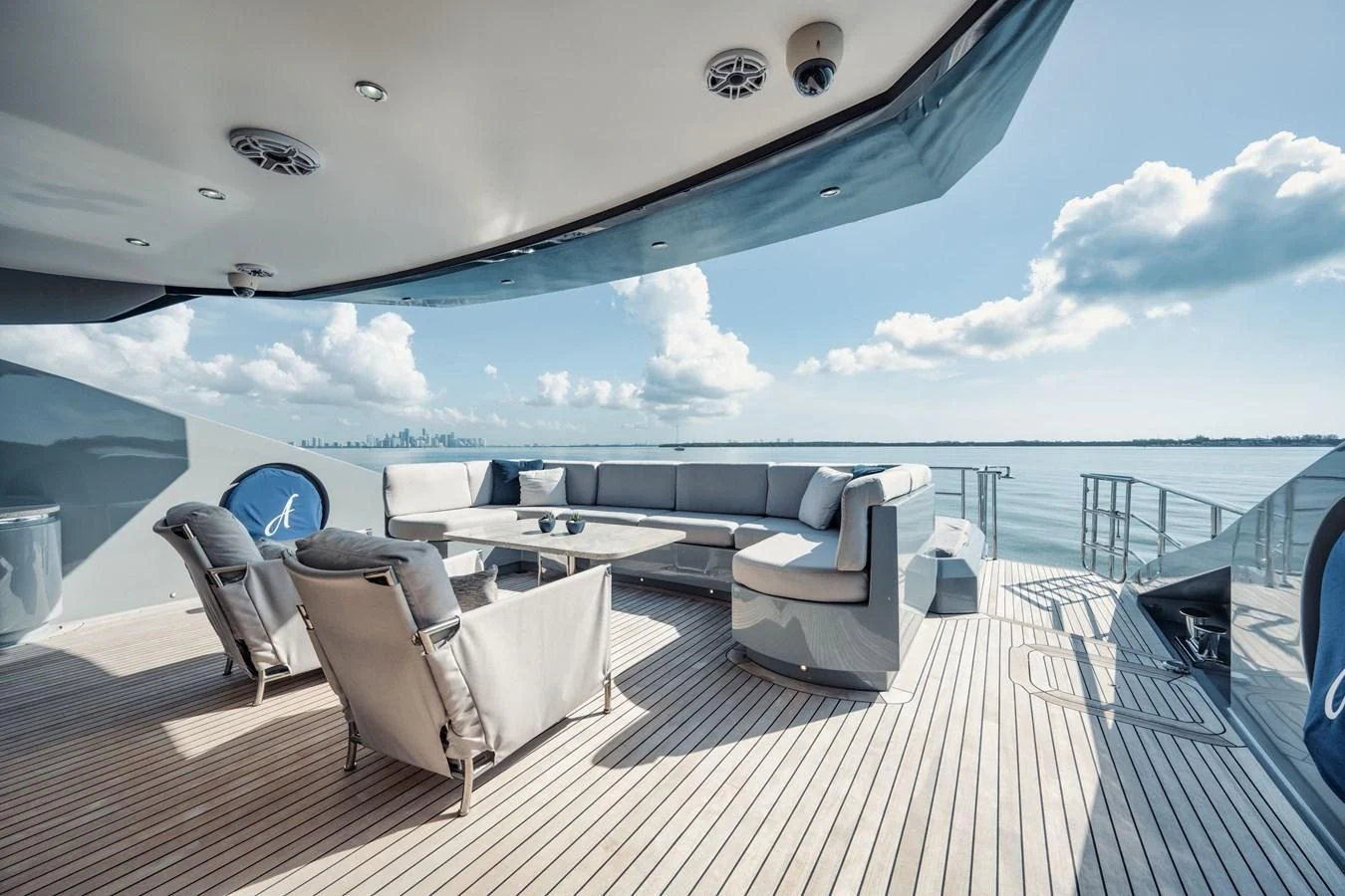 a deck with chairs and a table on it aboard AQUANOVA Yacht for Sale