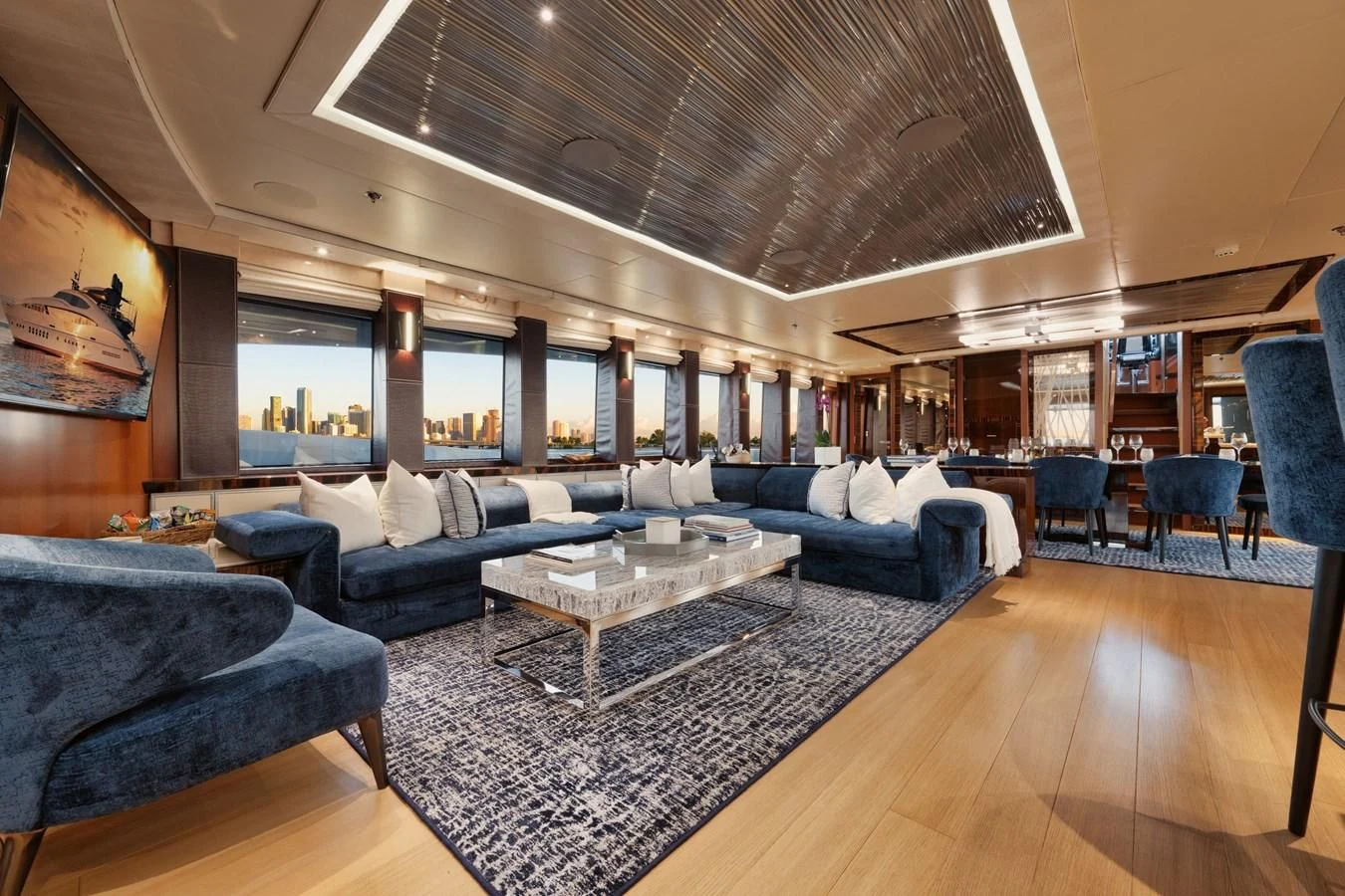 a living room with a large wood floor aboard AQUANOVA Yacht for Sale