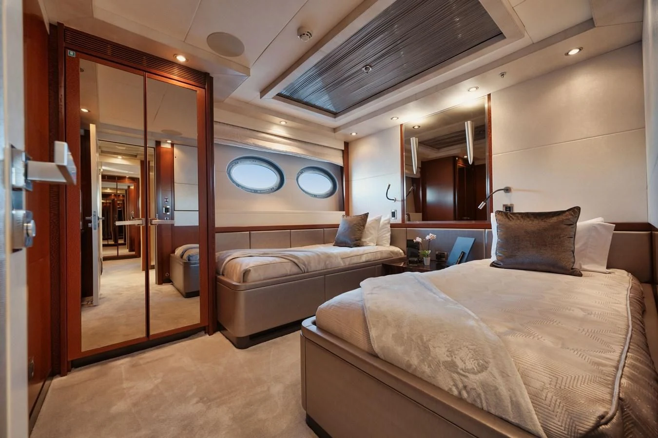 a bedroom with a bed and a mirror aboard AQUANOVA Yacht for Sale