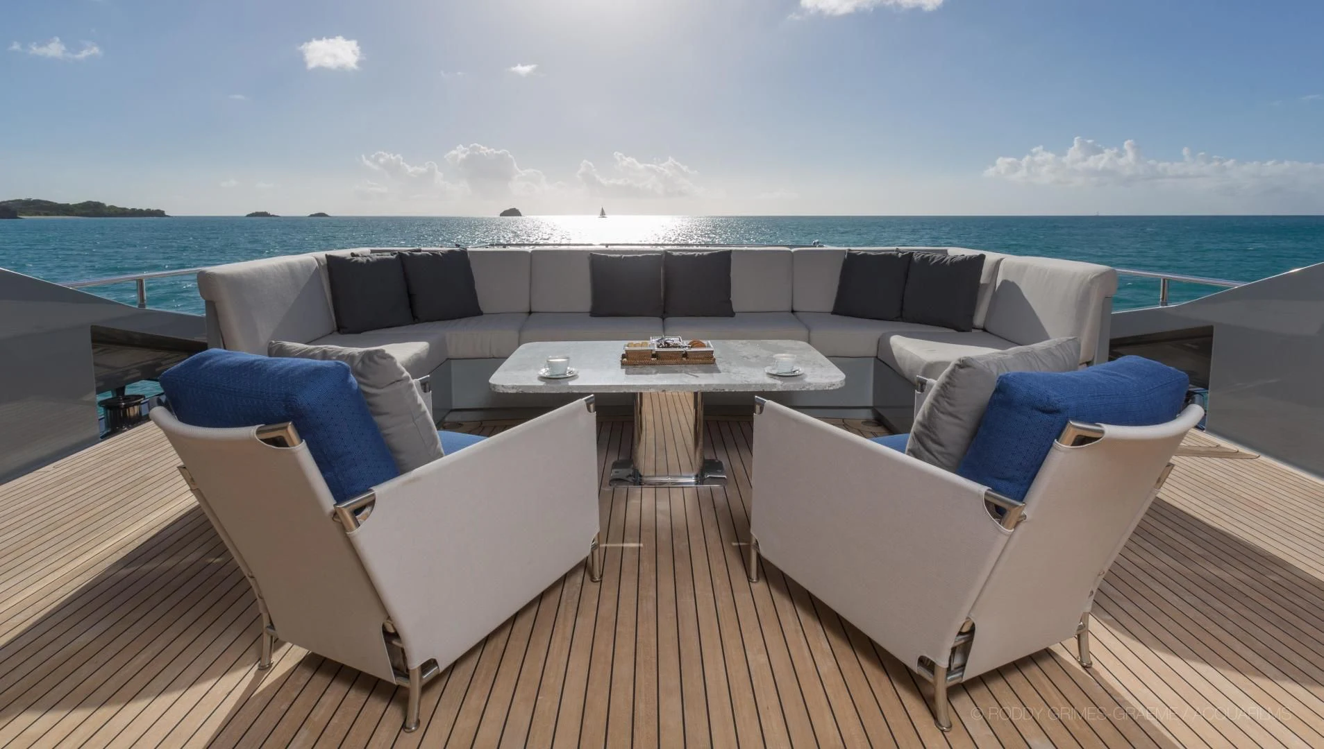 a deck with chairs and a table on it aboard AQUANOVA Yacht for Sale