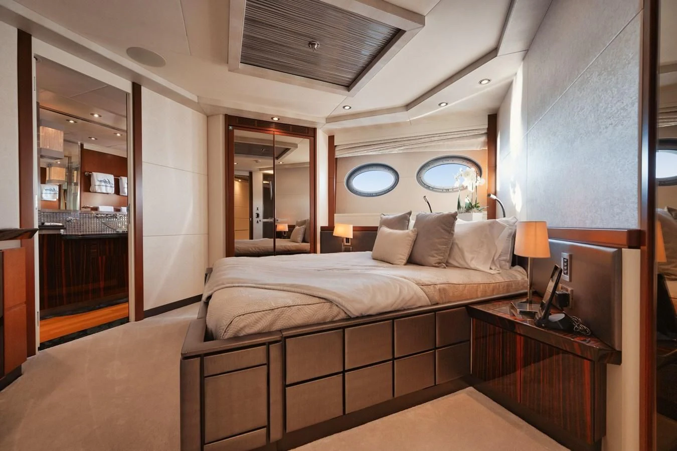 a bedroom with a bed and a mirror aboard AQUANOVA Yacht for Sale