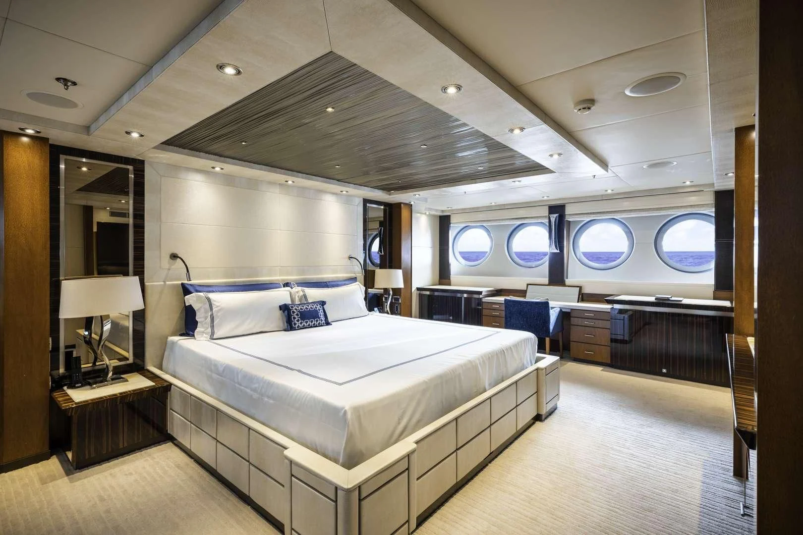 a room with a bed and a large mirror aboard AQUANOVA Yacht for Sale