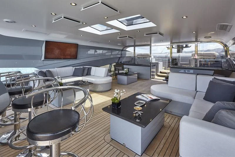 a room with a couch and a table with chairs aboard AQUANOVA Yacht for Sale
