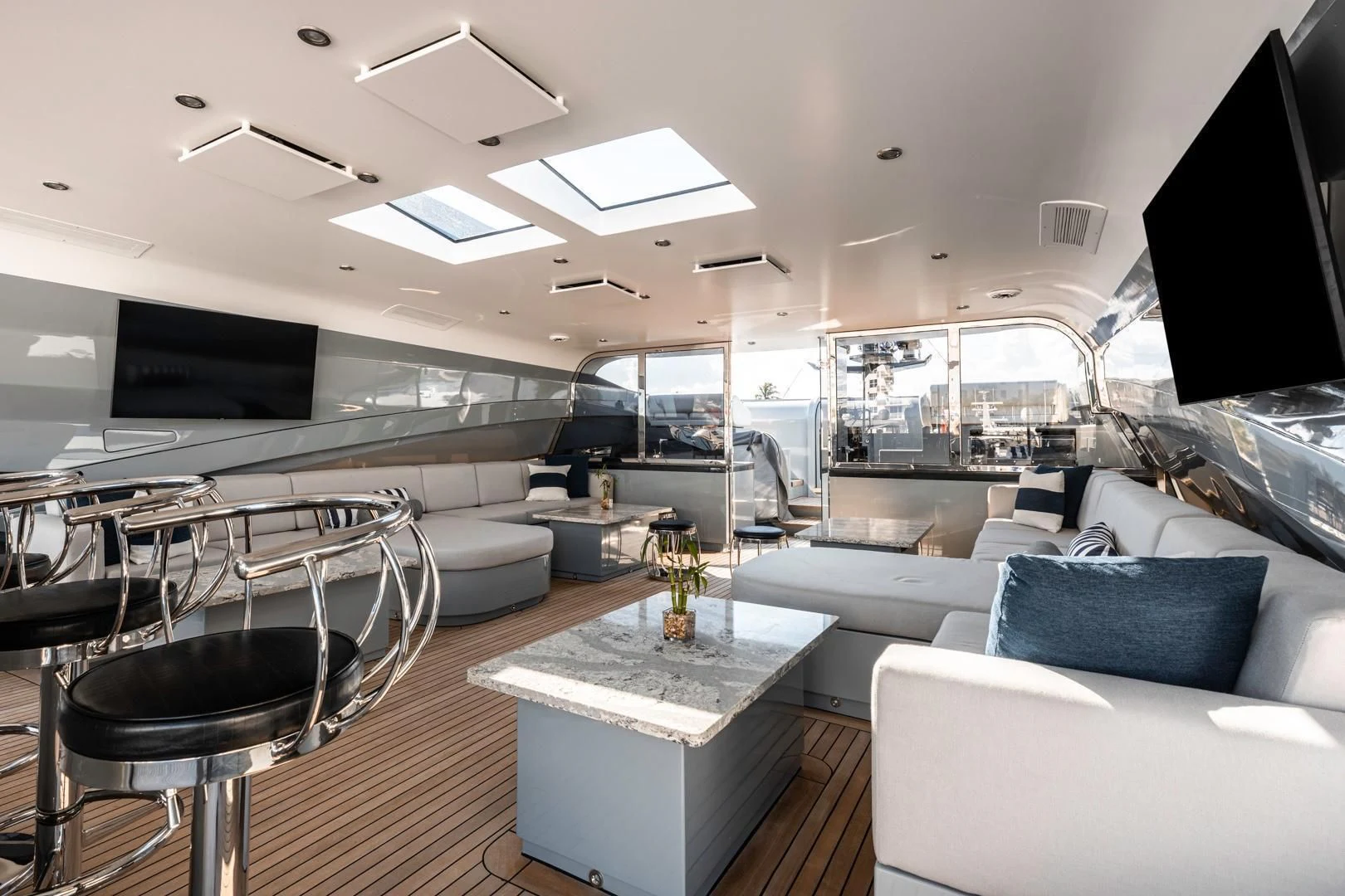 a room with a couch and a table and chairs aboard AQUANOVA Yacht for Sale
