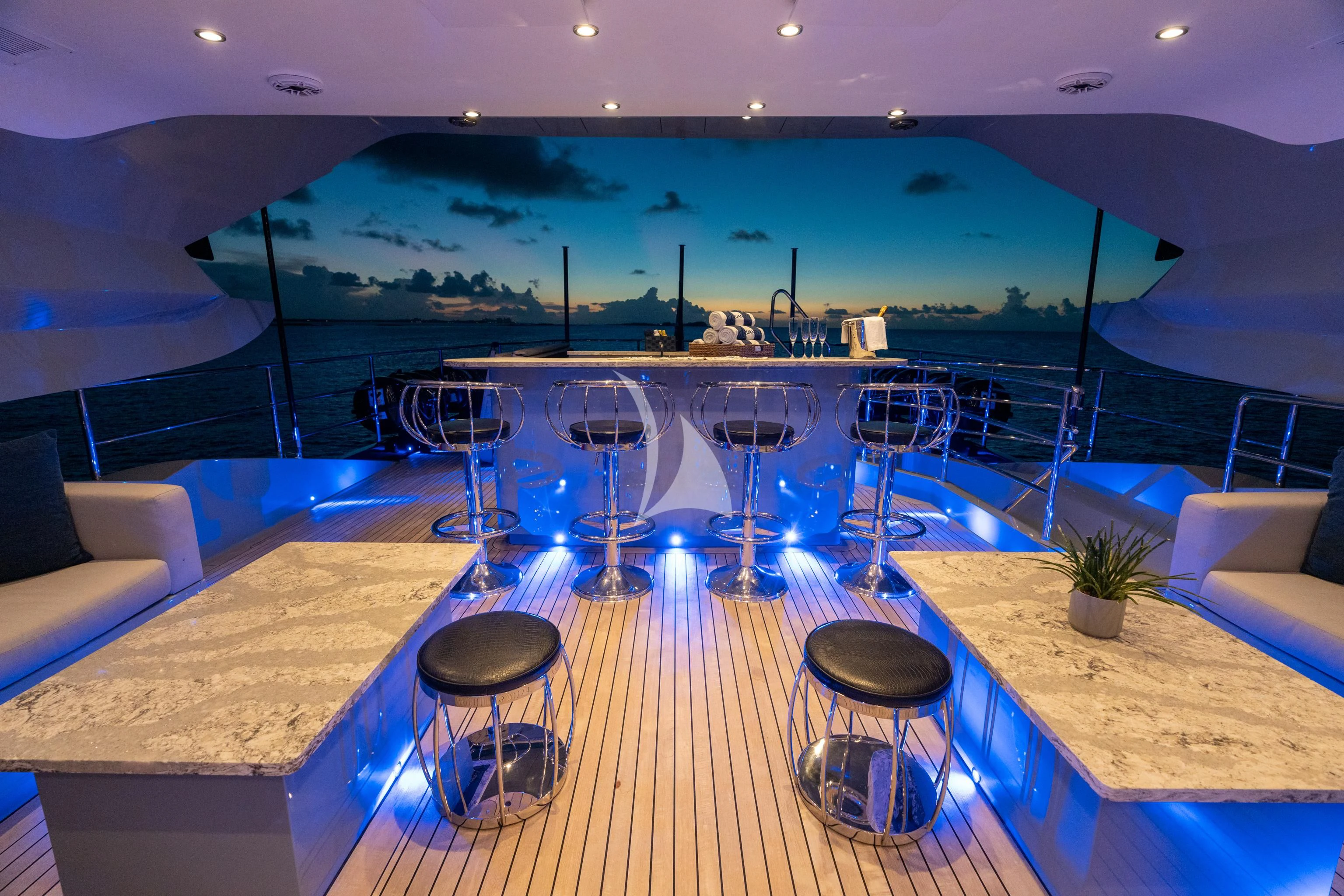 a deck with a table and chairs aboard AQUANOVA Yacht for Sale