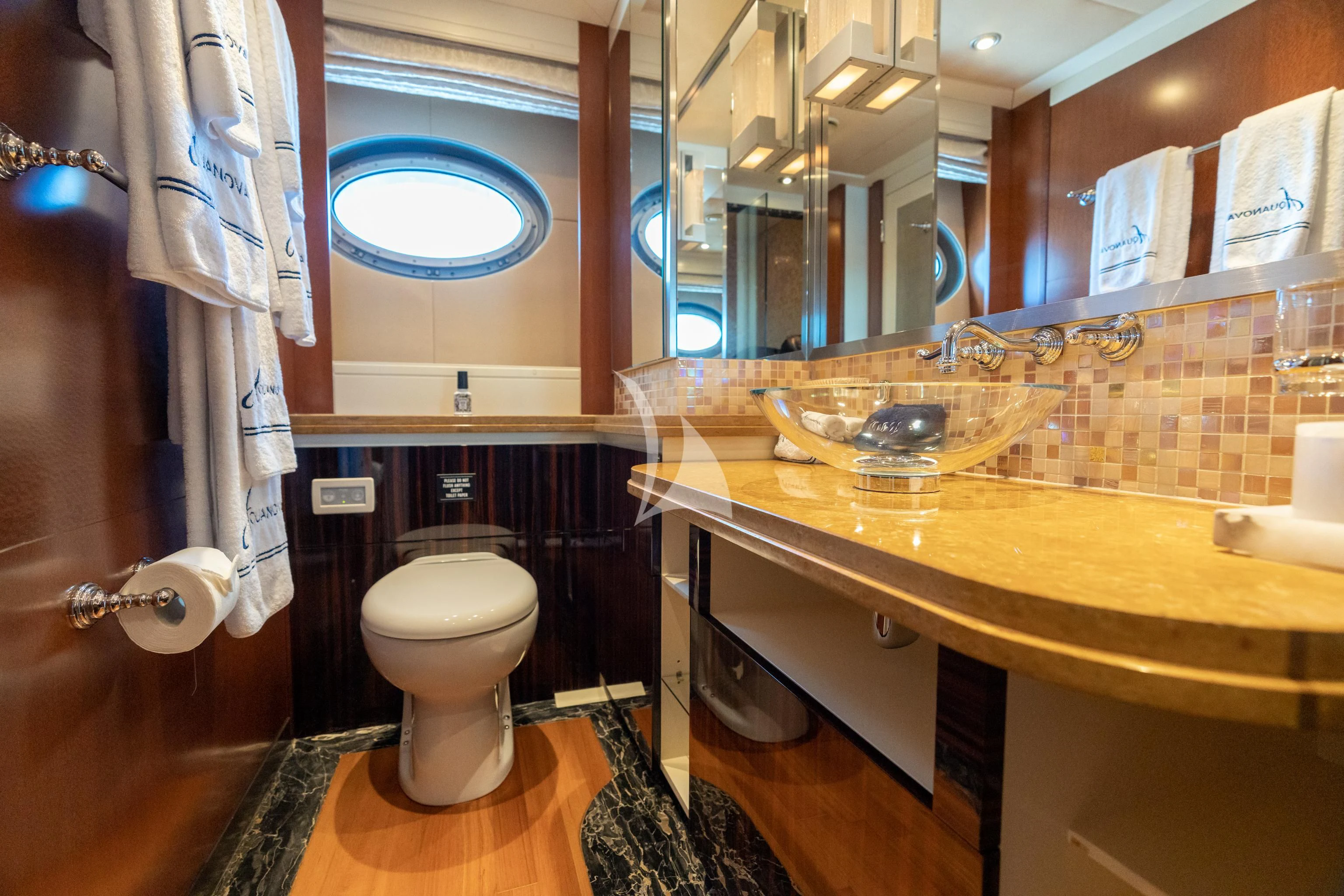 a bathroom with a toilet and a sink aboard AQUANOVA Yacht for Sale