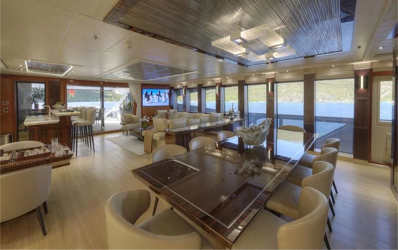 a large room with a table and chairs aboard AQUANOVA Yacht for Sale