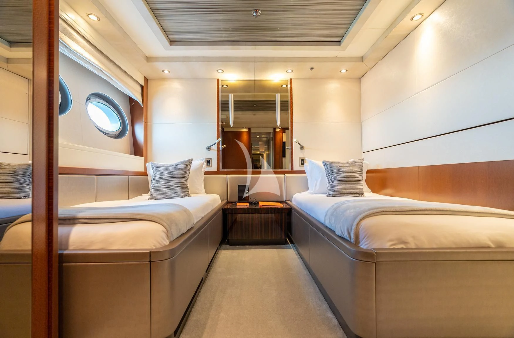 a room with beds and a mirror aboard AQUANOVA Yacht for Sale
