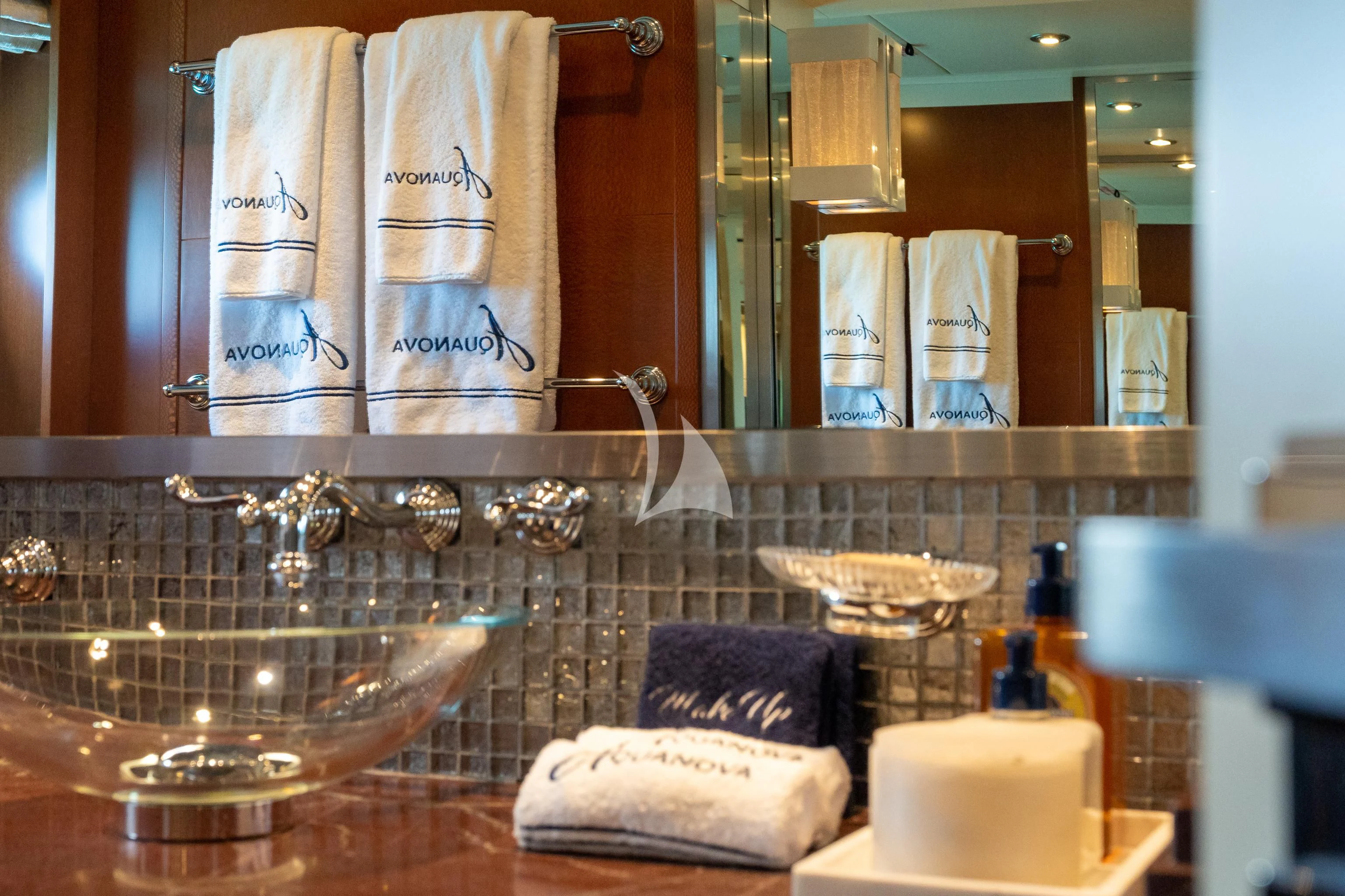 a bathroom with a sink and towels aboard AQUANOVA Yacht for Sale