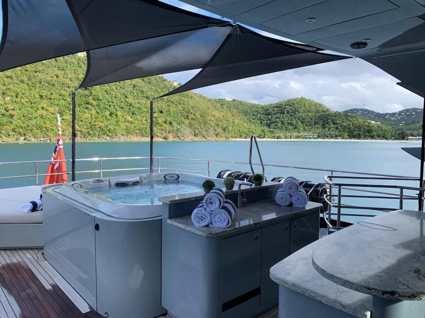 a large outdoor kitchen with a view of the water and trees aboard AQUANOVA Yacht for Sale
