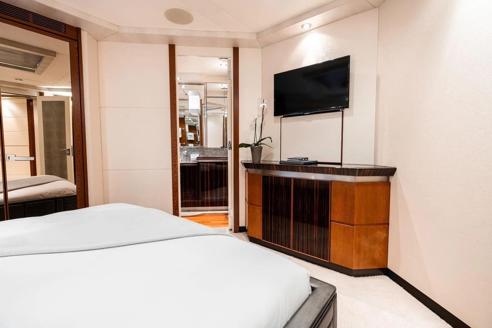a hotel room with a bed and tv aboard AQUANOVA Yacht for Sale