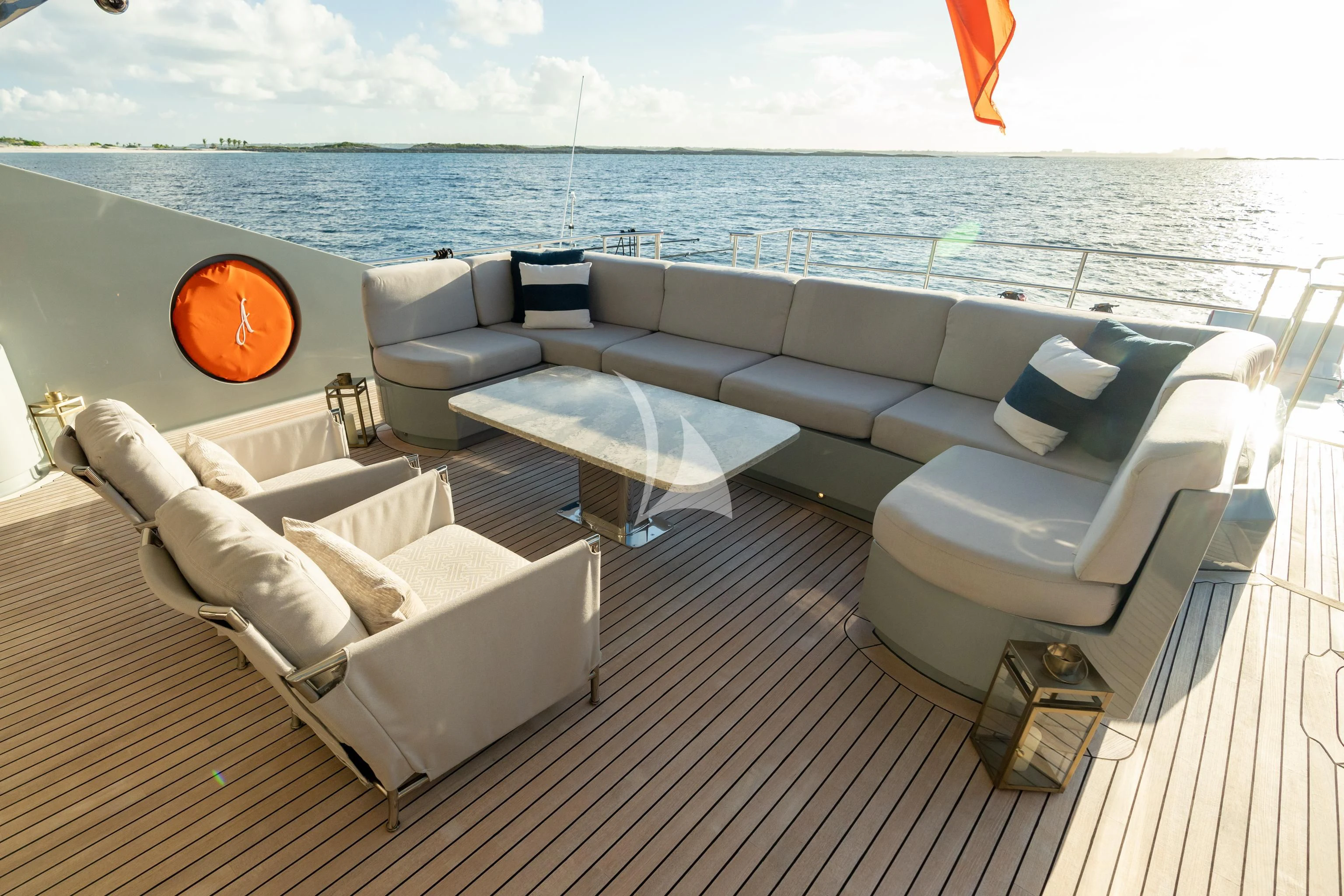 a large lounge area with a large body of water and a large orange ball on the wall aboard AQUANOVA Yacht for Sale