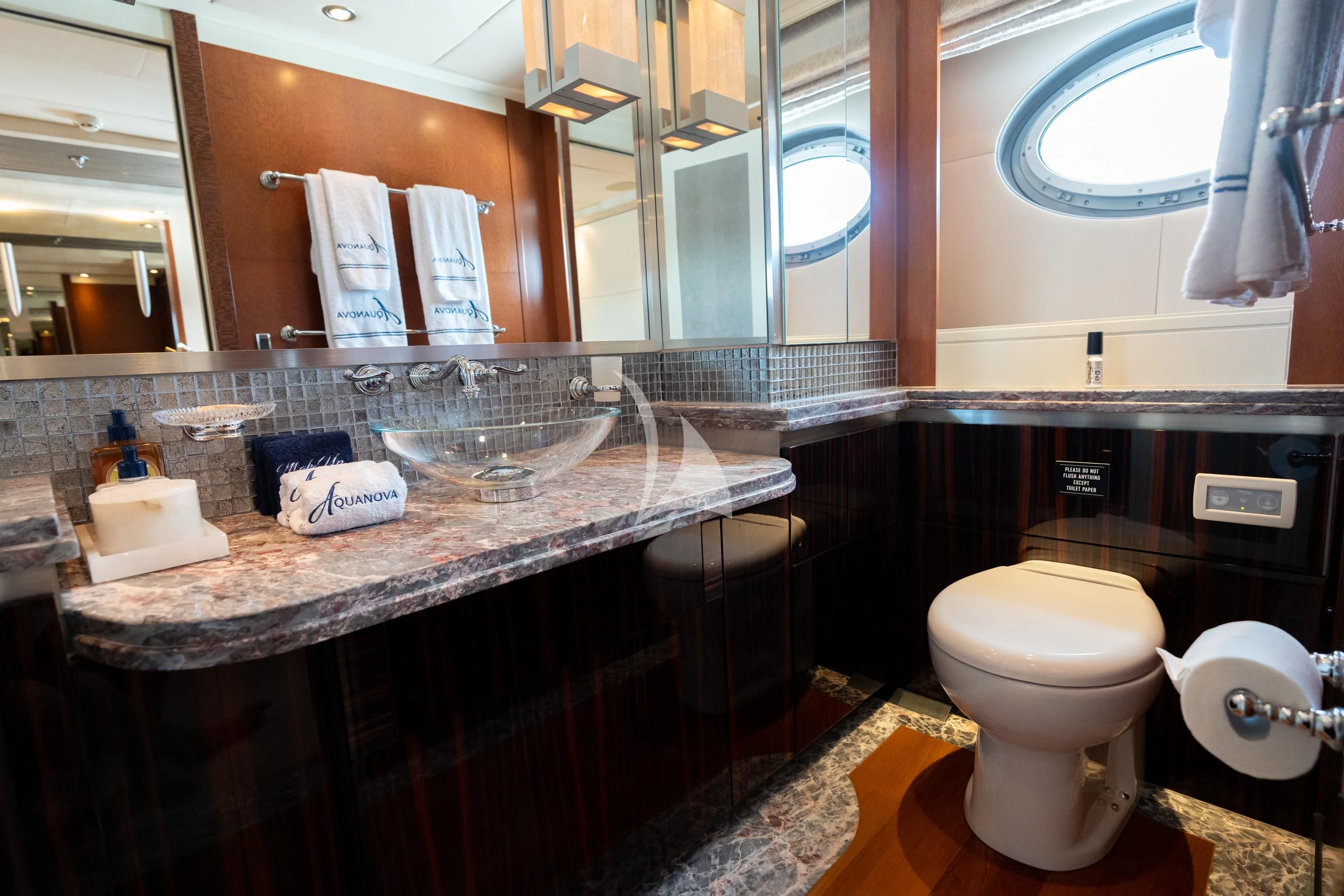 a bathroom with a countertop sink and toilet aboard AQUANOVA Yacht for Sale