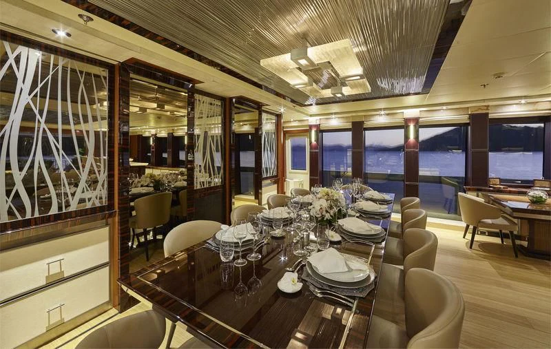 a room with tables and chairs aboard AQUANOVA Yacht for Sale