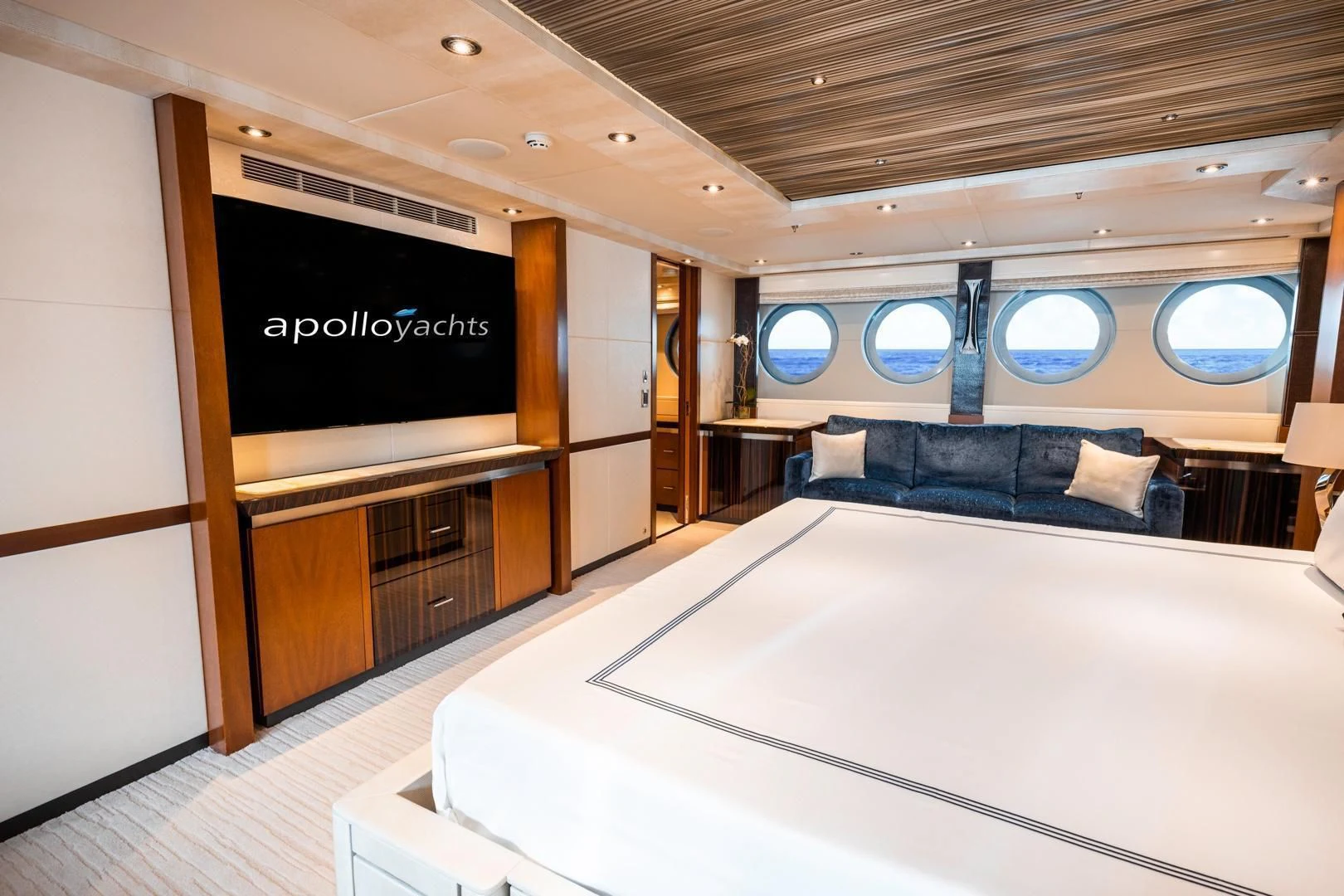 a room with a bed and a large screen aboard AQUANOVA Yacht for Sale