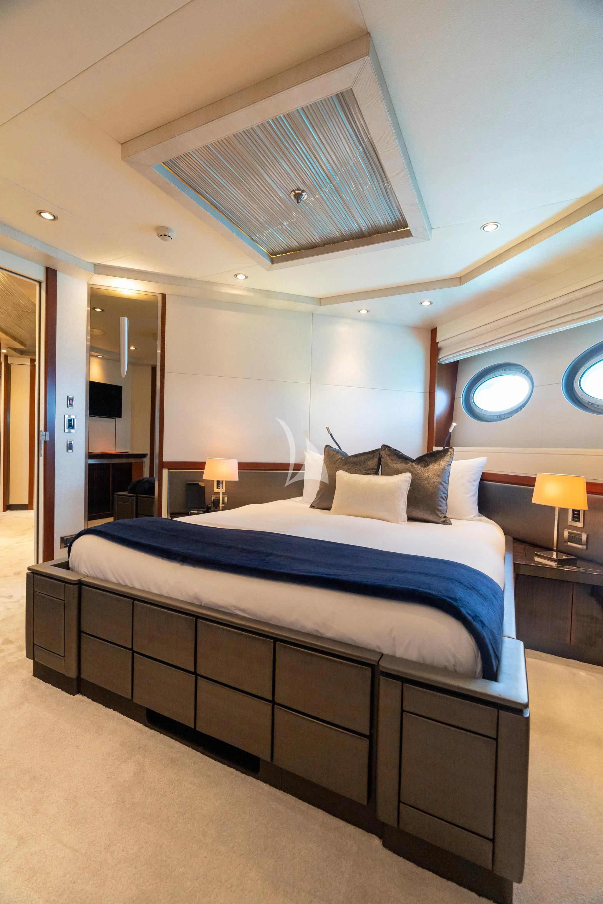 a bed with a blue bed spread aboard AQUANOVA Yacht for Sale