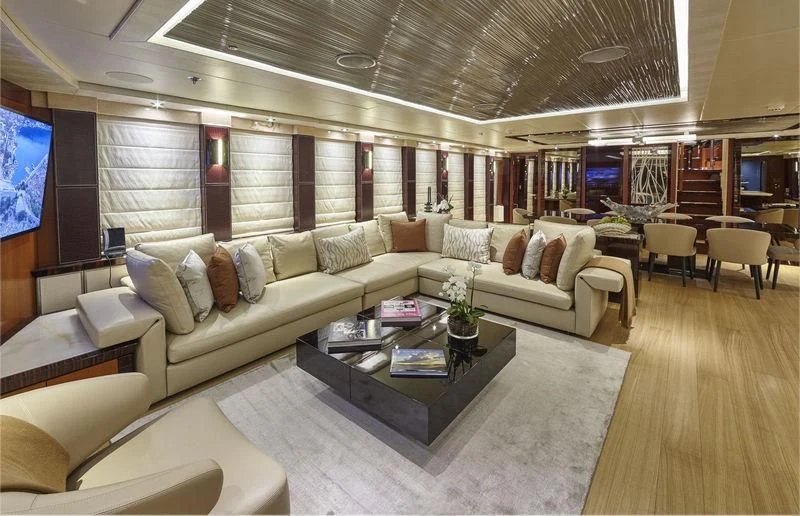 a living room with a large sofa aboard AQUANOVA Yacht for Sale