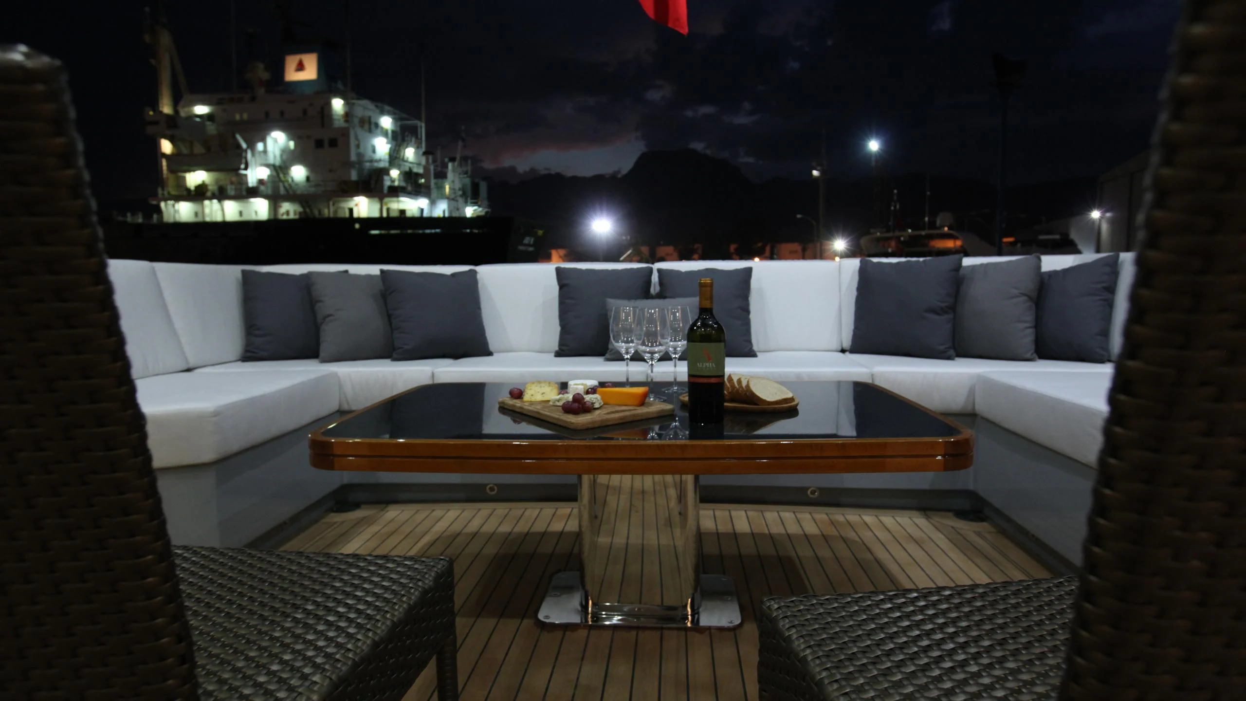 a table with a glass of wine on it aboard AQUANOVA Yacht for Sale
