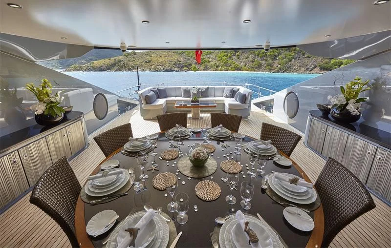 a table set with plates and silverware aboard AQUANOVA Yacht for Sale