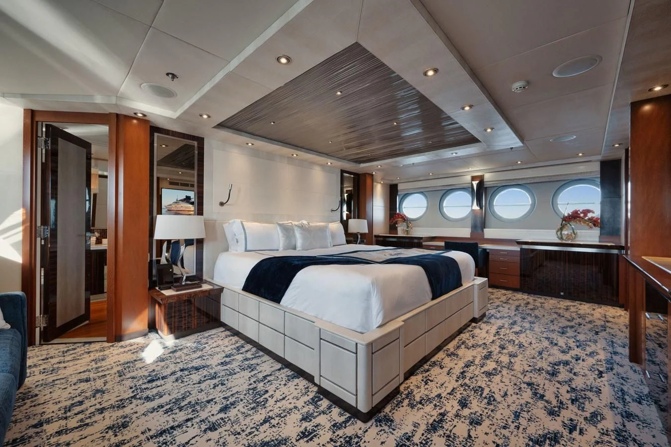 a room with a bed and a mirror aboard AQUANOVA Yacht for Sale