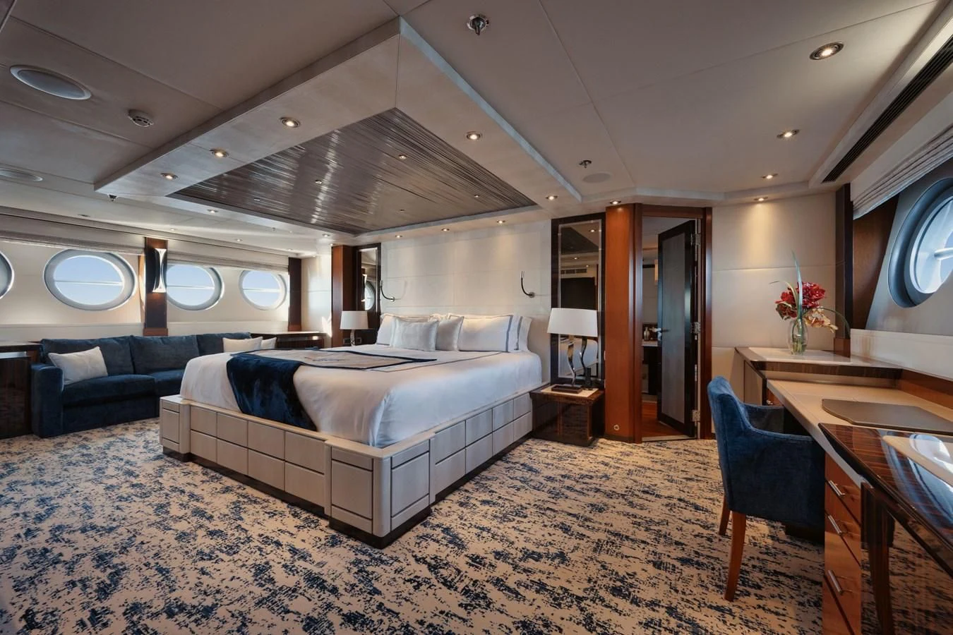 a bedroom with a bed and desk aboard AQUANOVA Yacht for Sale
