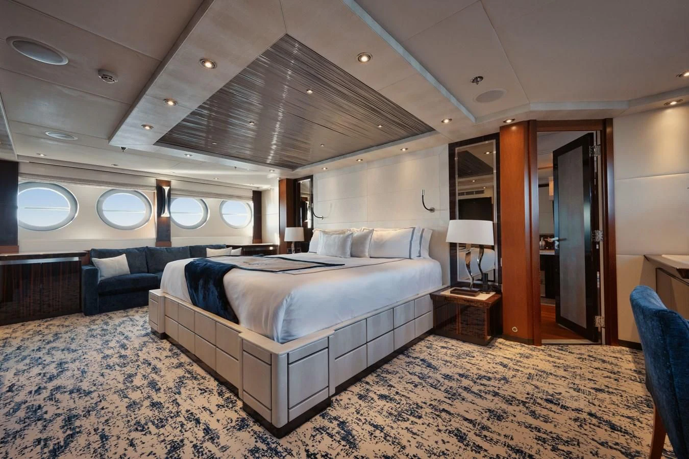 a large bedroom with a bed and a couch aboard AQUANOVA Yacht for Sale