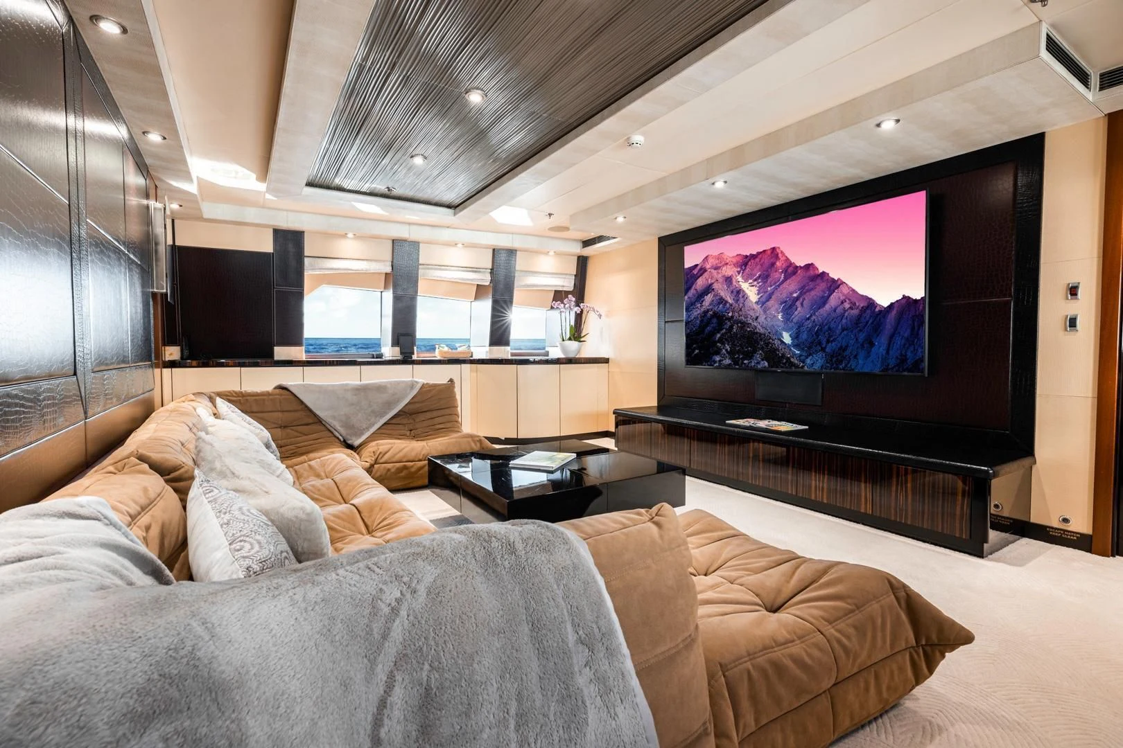 a large living room with a large screen aboard AQUANOVA Yacht for Sale