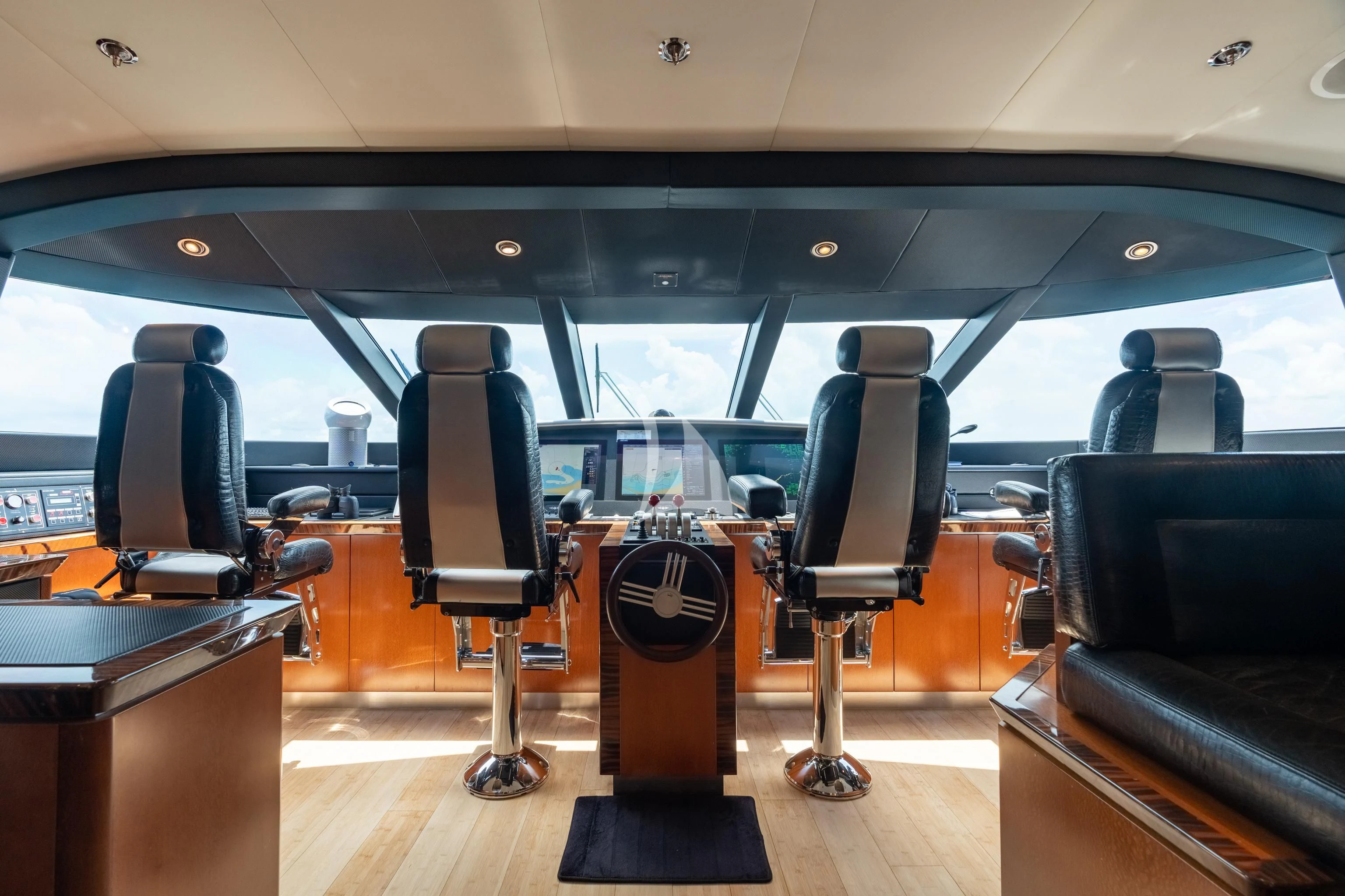 inside of a vehicle with chairs and a table and a seat aboard AQUANOVA Yacht for Sale